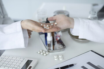 Close up of doctor holding pills