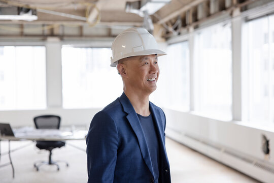Portrait of architect in hard hat working on office remodel