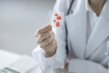 Close up of doctor holding pills