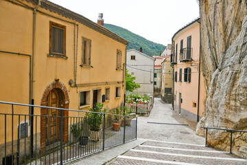 Fototapeta na wymiar A small street between the old houses of Pietrabbondante, a medieval village in the mountains of the Molise region in Italy.