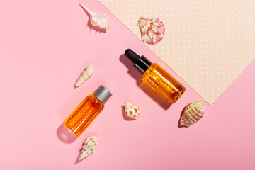 Tanning oil. Cosmetic products next to seashells in sunbeams on a pink background. Sun protective cosmetics.