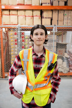 Portrait confident male warehouse worker in protective workwear