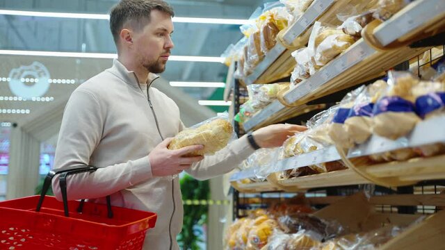 Man buying white bread in the supermarket