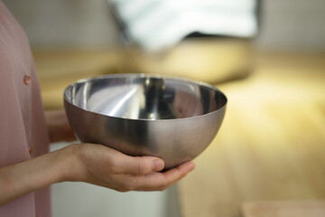 Woman holding bowl in kitchen