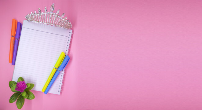 a blank paper with colorful pens and a crown on a pink background, ultra HD walpaper