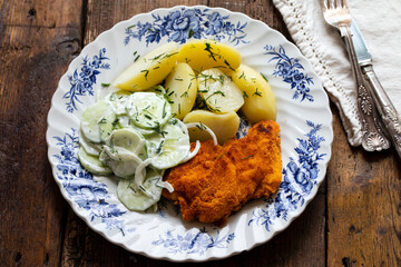 Chicken escalope, baby potatoes and cumcumber and onion salad