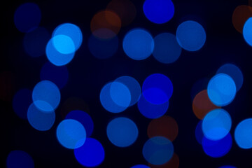 Blue bokeh on a black background. Abstract background