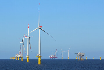 Industrial stations, wind turbines, and fuel stations in the middle of the ocean
