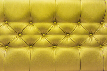 Yellow or gold leather upholstery sofa with pattern button design furniture style decor texture background