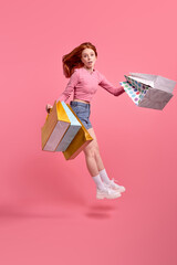 Cute Caucasian Female Casual Clothes Hurry After Shopping, Holding Packages With Purchase In Hands. People Lifestyle Concept. Mock Up Copy Space. Isolated Pink Background In Studio