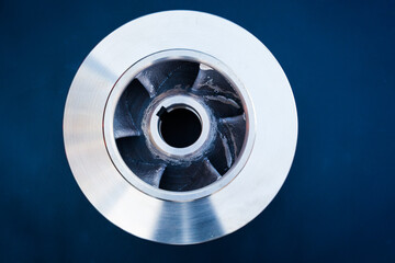 New bronze impeller on a dark blue background, top view.