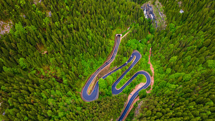 Winding road in the mountains, shot from a drone from a higher altitude and a low camera angle....