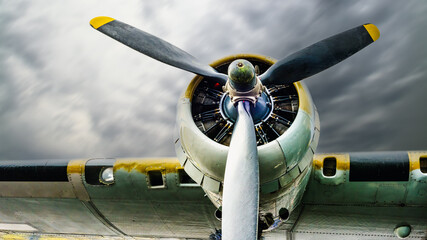 Vintage world war two bomber airplane wing, engine and propeller. Cloud filled sky. Room for copy text.
