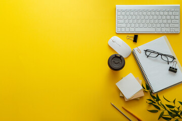 Work space desk layout with note pc keyboard coffee cup glasses bright color yellow background copy space. Modern office desk workspace flat lay composition. White stationery on home office workplace