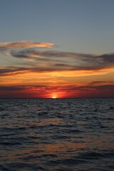 very beautiful red-yellow sunset in the sky and on the seashore