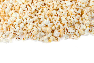 Heap of delicious popcorn, isolated on white background. Scattered popcorn texture background. Close-up.