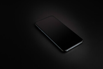 modern smartphone with triple-lens camera against dark background