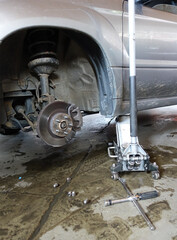 Fototapeta premium The structure and elements of suspension of a modern car. Shock absorber, suspension arm, spring, subframe. Concept repair and service of a modern car