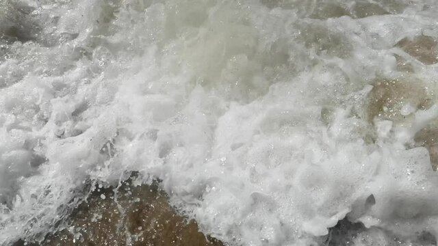 Slow motion footage of sea waves breaking on shore