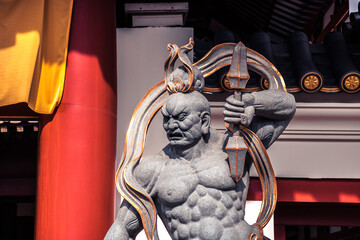 Fototapeta na wymiar Sculpture of ancient furious warrior guard at the enter to Buddha Tooth Relic Temple in Singapore in Chinatown 