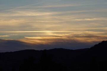 Sunset in a cloudy sky over the mountains in Norway