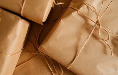Gifts or mail parcel packed in kraft paper. Boxes of different Simple packaging for the holiday.