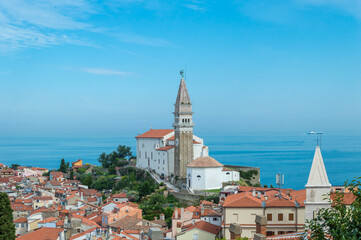 A panoramic of old town Piran, Slovenia. View over the tiled roofs of Piran and the Adriatic Sea.