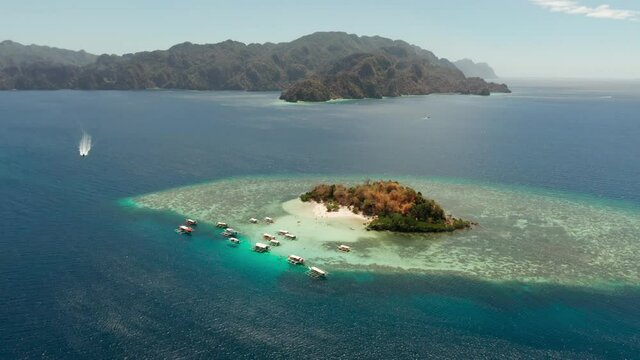 aerial view tropical island with sand white beach, clear and blue water. CYC Beach, Philippines, Palawan. Tropical landscape with blue lagoon, coral reef. travel concept
