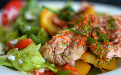 Pulled pork with salad and potatoes.