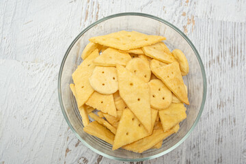 Delicious homemade crackers on white wooden table. Crunchy savory crackers snack idea for kids or adults