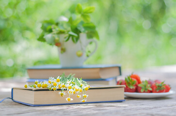 a bouquet of wild daisies on a book on a table