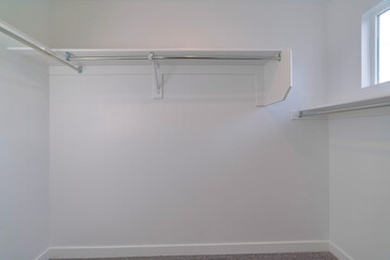 White wooden shelves and racks in the pantry or wardrobe room