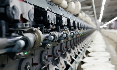 Naklejka na ściany i meble The process of machine operation in a textile factory for the production of cotton thread and yarn