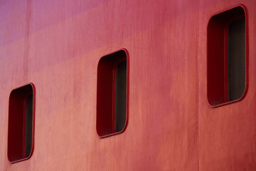 Three Rectangular Portholes On A Red Ship Hull, Cape Town, South Africa