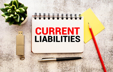 text Current Liabilities on white paper, concept
