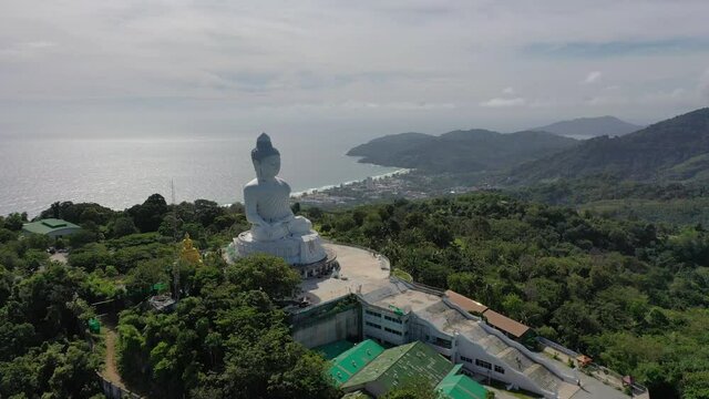 aerial photography Phuket big Buddha in sunny day.Phuket Big Buddha is one of the most important and revered landmarks on Phuket island..white cloud in blue sky, blue sea and mountain background.
