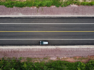 Top view of a country road with cars parked on the side of the road, drone aerial shot