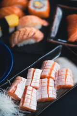 Salmon Sashimi with belly, Japanese buffet restaurant.Fresh salmon fillet on black plate salmon slices.Asian people eating sashimi set Japan restaurant.salmon sashimi.Asian Food Menu.seafood sashimi.