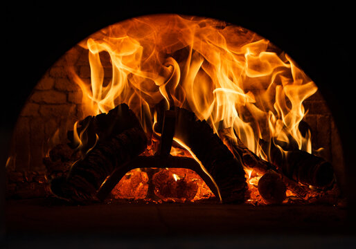 Traditional brick pita oven, burning wood and flames