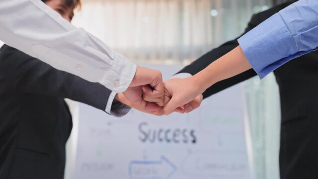 Group of business people fist bump to motivate for success in unity.