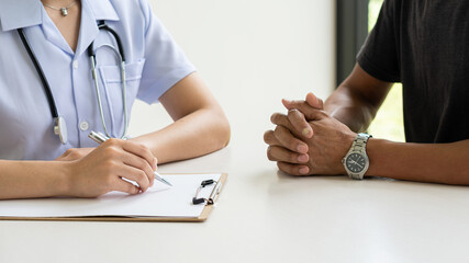 A female doctor treating a patient makes an appointment to hear the results after a physical examination. along with explaining medical information and diagnosis