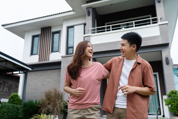 Fototapeta premium cheerful couple standing outside their house