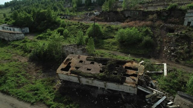 the ruins and ruins of an abandoned mine, an old industrial building overgrown with forest, as a location for thriller and depressing horror films