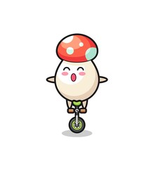 The cute mushroom character is riding a circus bike