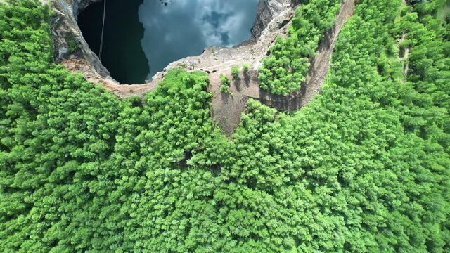 mountain lake and coniferous green forest. aerial view turquoise water in the mountains, Tuimsky sinkhole-man-made disaster mine collapse in Khakassia russia