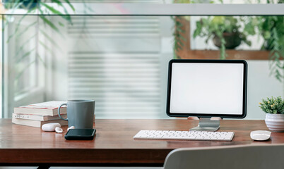 Comfortable workspace in modern room with tablet on stand.