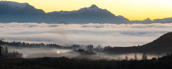 Panoramic view of mountains above the clouds at sunrise