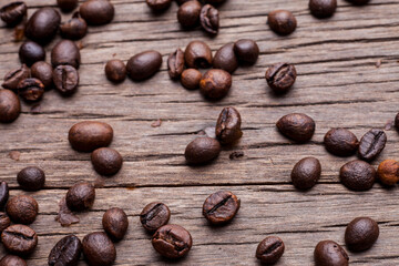 Coffee beans on old wooden floor background..