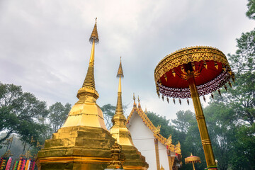 Doi Tung twin golden Buddha's relics in foggy day at Chiang Rai province norther of Thailand