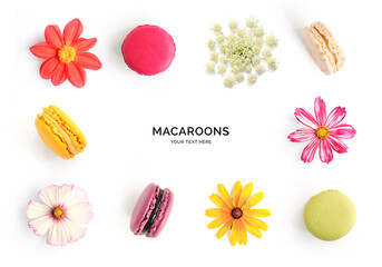 Creative layout made of flowers and macaroons isolated on white background. Flat lay. Food concept.